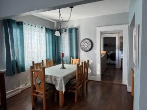 a dining room with a table and chairs and a clock at Casa 131 in Tucson