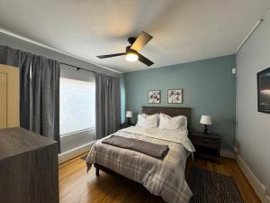 a bedroom with a bed and a ceiling fan at Casa 131 in Tucson