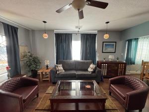 a living room with a couch and chairs and a table at Casa 131 in Tucson