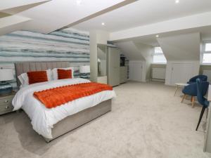 a bedroom with a bed and a painting on the wall at Eleven Tides in Seaham