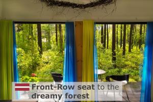 a view of a forest from a window with front row seat to the charity forest at Rabarberi LV just 15min walk to SeaSide in Saulkrasti