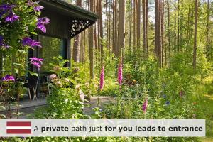 a private path just for you leads to entrance in a garden at Rabarberi LV just 15min walk to SeaSide in Saulkrasti