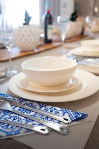 a table with plates and utensils on a table at LazyYzer in Yzerfontein