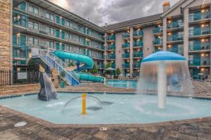 a pool at a hotel with a water slide at Accommodations By Willow Brook Lodge in Pigeon Forge
