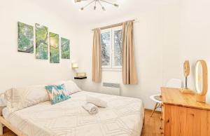 a bedroom with a bed and a desk and a window at Chalet de Seyne in Seyne
