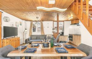 a dining room with a wooden table with chairs at Chalet de Seyne in Seyne