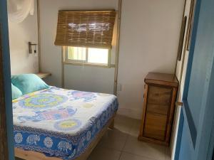 a small bedroom with a bed and a window at Milagros in La Paloma