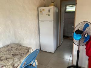 a kitchen with a white refrigerator and a fan at Milagros in La Paloma