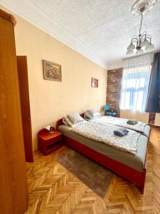 a bedroom with a bed in a room at Èlmèny Vendègház in Csurgó +35 photos