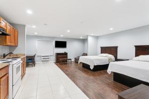a hotel room with two beds and a kitchen at Laplace Motel in Laplace