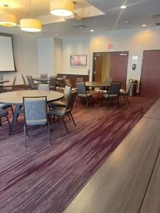 a conference room with tables and chairs and a chalkboard at Courtyard Marriott Houston Pearland in Pearland +21 photos