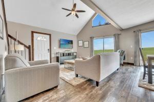 a living room with two chairs and a ceiling fan at Bridges Bay Vacation Cabin 279 in Arnolds Park
