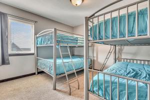 a bunk room with two bunk beds and a window at Bridges Bay Vacation Cabin 279 in Arnolds Park +75 photos