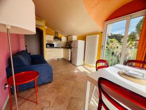 a living room with a blue couch and a kitchen at Suite La Brezza - Luxury Sanremo in Sanremo +20 photos