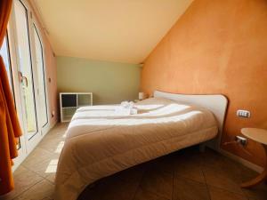 a bedroom with a bed and a large window at Suite La Brezza - Luxury Sanremo in Sanremo