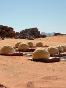 a group of domes sitting in the desert at Luxury Camp Wadi Rum in Disah +60 photos