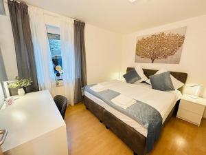 a bedroom with a bed and a desk and a window at Fewo am Disselhook in Lüdinghausen