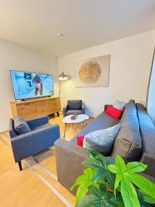 a living room with a couch and a flat screen tv at Fewo am Disselhook in Lüdinghausen