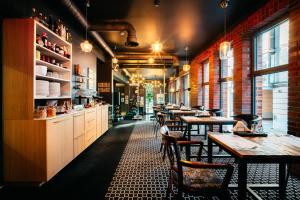 a row of tables and chairs in a restaurant at Cocorico Bed and Breakfast OLD TOWN Szczecin Adults Only in Szczecin