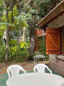 a white table and two chairs and a table and a table and chairs at OKIN 25 New in Costa del Este