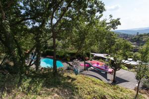a villa with a swimming pool and trees at Loft "Home, Sauna & Pool" in Osenbach