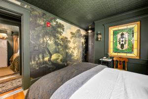a bedroom with a large painting on the wall at The Gaslamp Bed and Breakfast in Provincetown