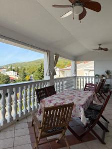 a bedroom with a table and chairs on a balcony at Apartment Ornik in Crikvenica