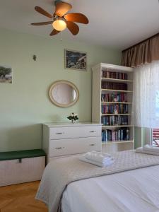 a bedroom with a bed with a ceiling fan at Apartment Ornik in Crikvenica