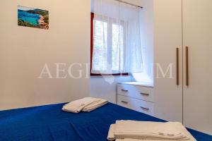 a bedroom with a blue bed and a window at Carla 1 in Campese