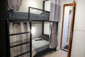 two bunk beds in a room with a mirror at Favela Hostel in Rio de Janeiro