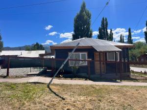 a house with a hose coming out of it at Departamentos Confluencia in Cochrane +4 photos