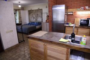 a kitchen with a sink and a refrigerator at Minimax in Odesa
