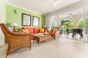 a living room with a couch and chairs and a table at 101 Sapphire Beach Barbados in Christ Church