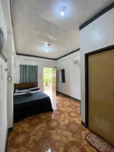 a bedroom with a bed and a tv in a room at Angel Gabriel Homestay in Coron +8 photos