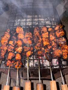 a bunch of food cooking on a grill at Sameer Homestay in Kalimpong