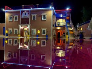 a house with lights on the side of it at night at Riad lina in Tafraout