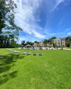a group of chairs sitting in a grass field at Howard Johnson Pilar Resort Spa & Convention Center in Pilar