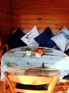 a bed with blue and white pillows on it at Chalet à la campagne in Clais