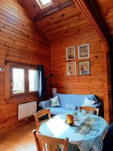 a living room with a table and a couch at Chalet à la campagne in Clais