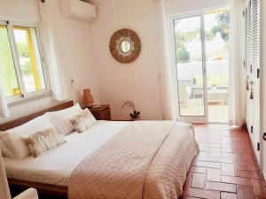 a bedroom with a large bed and a large window at Villa Blue - Aldeia do Golfe in Quarteira +34 photos