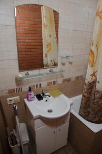a bathroom with a sink and a mirror and a tub at Minimax in Odesa +27 photos