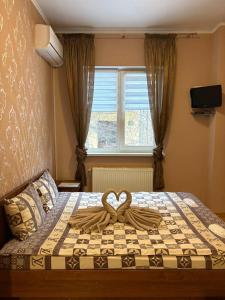a bedroom with a bed with a heart decoration on it at Відпочинковий комплекс,міні готель Старий дворик in Lviv