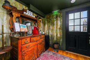 a room with a wooden dresser and a mirror at The Gaslamp Bed and Breakfast in Provincetown +61 photos