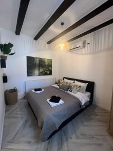 a bedroom with a bed with two towels on it at One Bedroom Apartment with Terrace in Oradea
