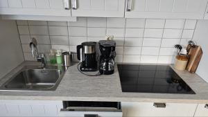a kitchen counter with a sink next to a sink at Lillstugan i Rasbo in Uppsala