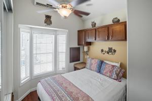 a bedroom with a bed and a ceiling fan at Live Oak Landing in Freeport