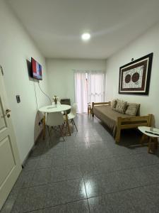 a living room with a bed and a table at Santa Genoveva in Neuquén