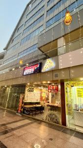 a store front of a building with a sign on it at Sundowner Hive115 Jacuzzi studio Large grdan patio in Gurgaon