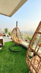 a room with a hammock and grass at Sundowner Hive115 Jacuzzi studio Large grdan patio in Gurgaon