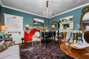 a living room with a table and a desk at The Gaslamp Bed and Breakfast in Provincetown